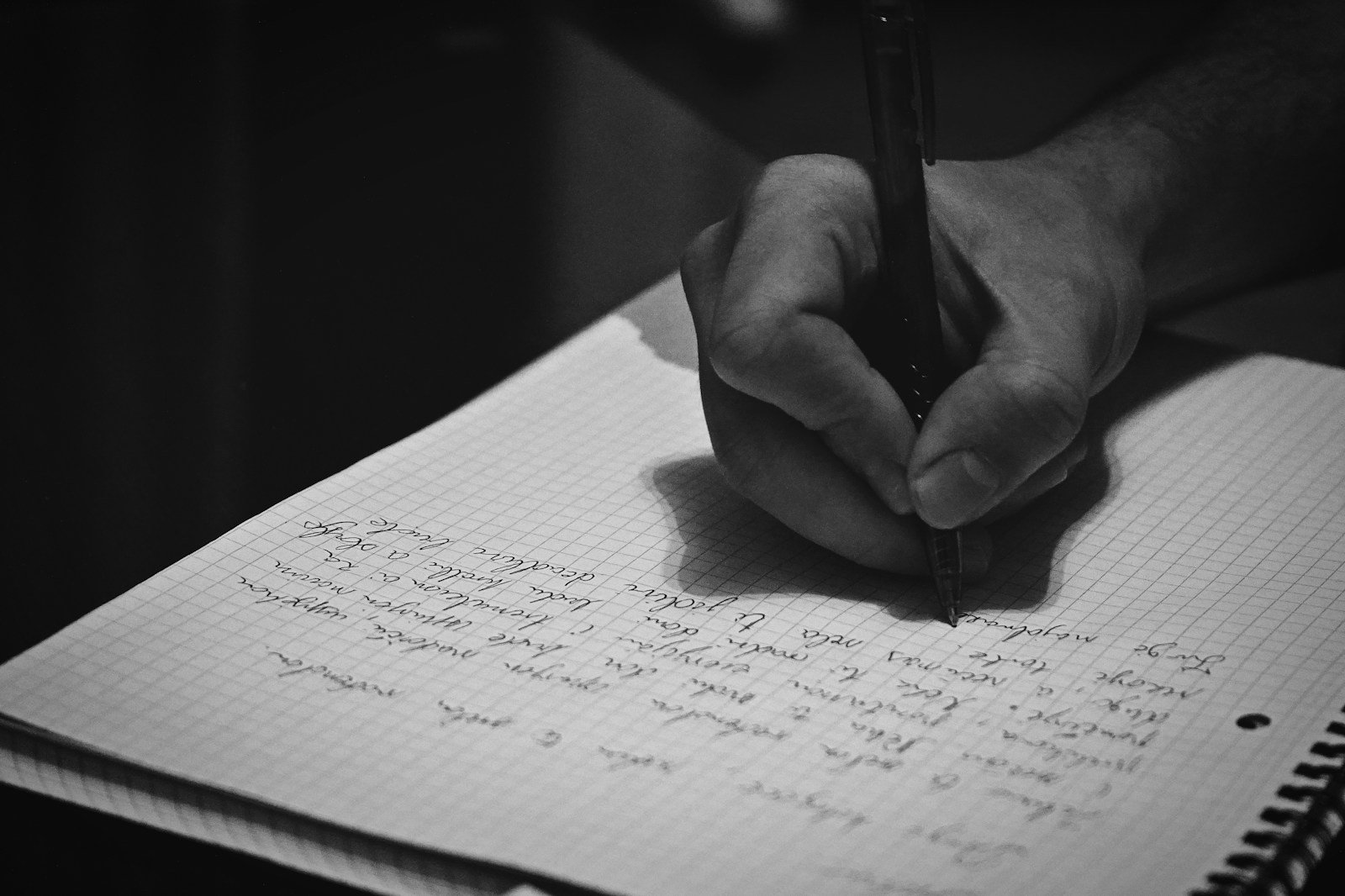 Hands holding a pen, writing in a notebook — symbolizing reflection, growth, and writing a letter to a younger self.